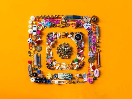Image of Instagram logo made up of various objects on orange background.