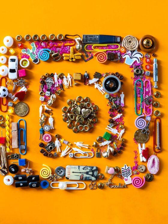 Image of Instagram logo made up of various objects on orange background.
